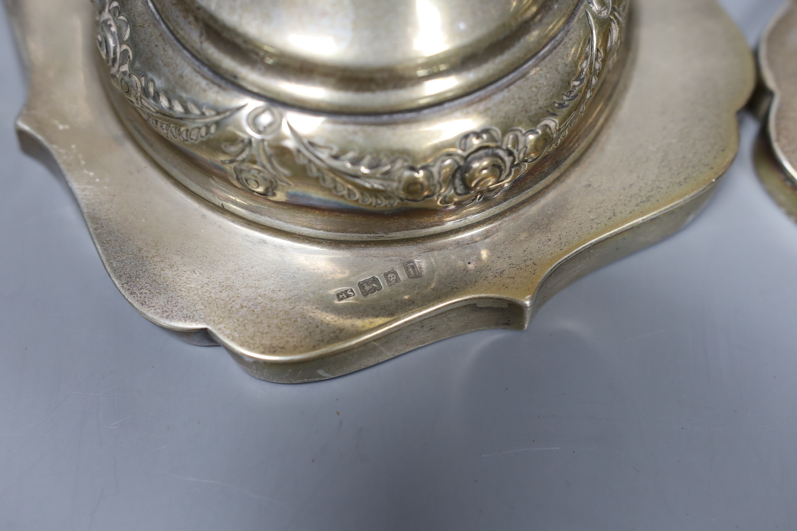 A pair of George V silver candlesticks, with floral swagged knopped stems, London 1924, 36cm, 30.5 oz.